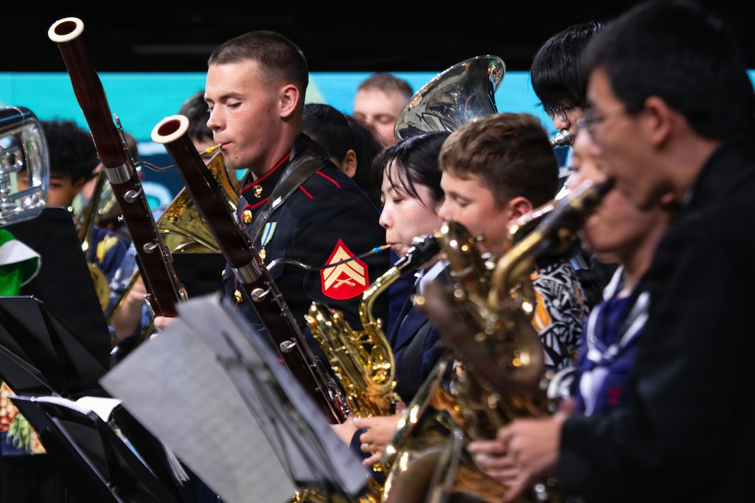 U.S. Marine Cpl. Aidan Ehrlich (left), a bassoonist with the III Marine Expeditionary Force Band, performs alongside local musicians during the Japan – U.S. Joint Concert, Jan. 17, 2026, at the Okinawa SUNTORY Arena, Okinawa, Japan. The event was hosted by the Okinawa Defense Bureau, Ministry of Defense, and featured performances from local middle schools, the Japan Ground Self-Defense Force 15th Brigade Band, and the Japan Air Self-Defense Force Southwestern Band. The Marines performed alongside the attending bands to build and strengthen their relationships with the local community and their partner organizations. Ehrlich is a native of Texas. (U.S. Marine Corps photo by Staff Sgt. Shannon Doherty)