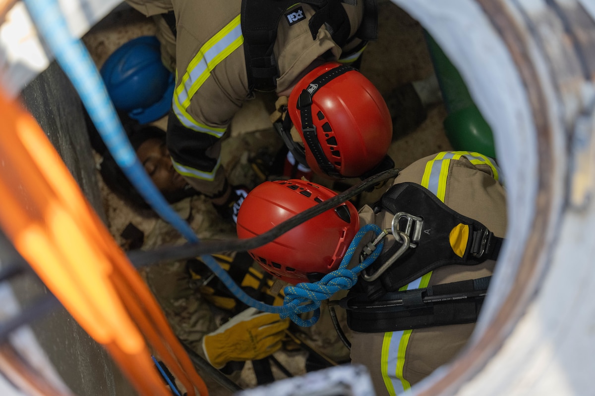 Members of the 97th Civil Engineer Squadron simulate a confined space rescue at Altus Air Force Base, Oklahoma, Jan. 21, 2026. The training simulated rescuing a water and fuel systems maintenance journeyman that had passed out due to atmospheric hazards caused by a gas leak in a confined space. (U.S. Air Force photo by Airman 1st Class Emma Wright)