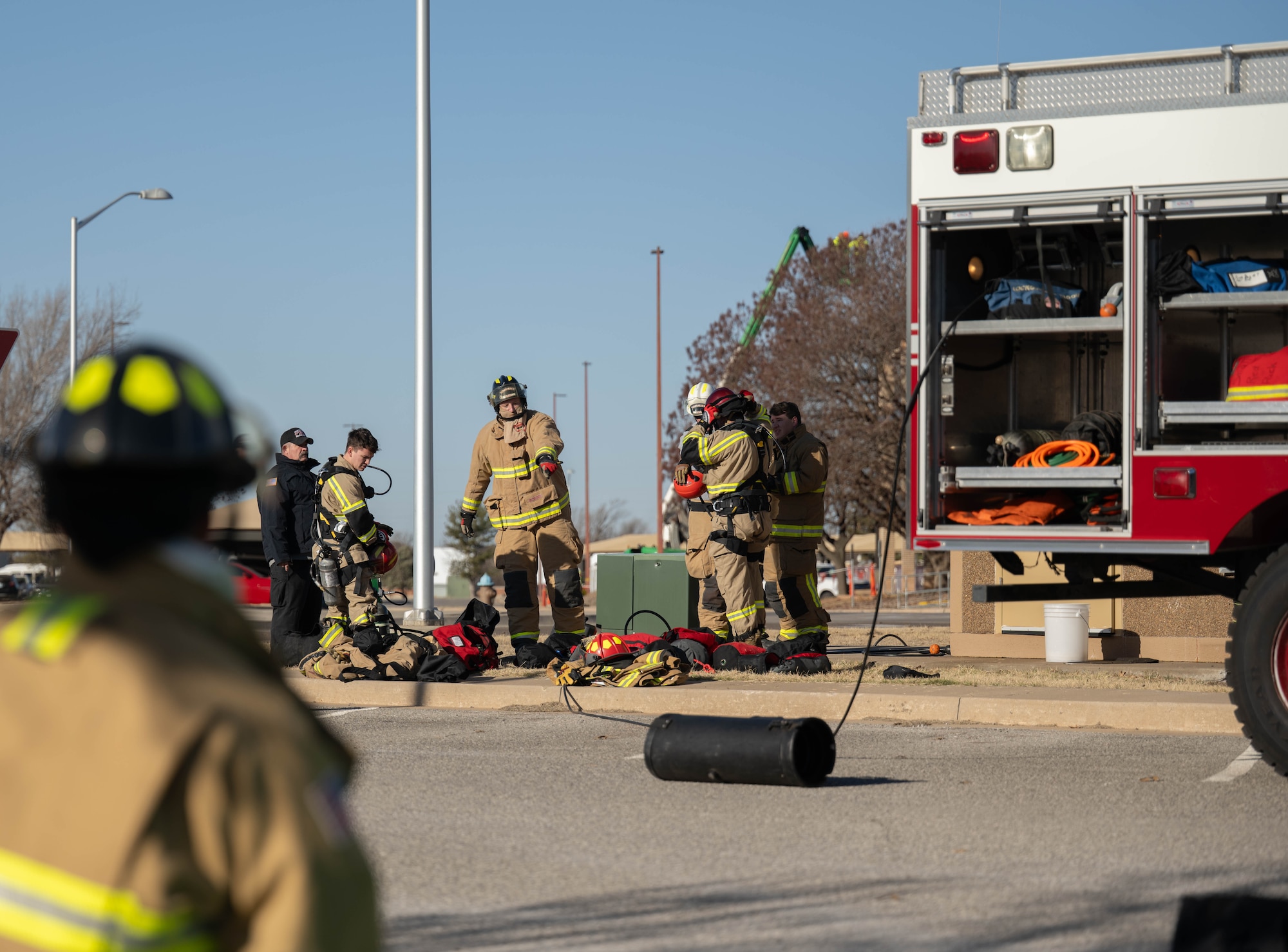 Members of the Altus Air Force Base Fire Department put on their personal protective equipment at Altus Air Force Base, Oklahoma, Jan. 20, 2026. The 97th Civil Engineer Squadron took part in a confined space awareness, operations and technician training. (U.S. Air Force photo by Airman 1st Class Emma Wright)