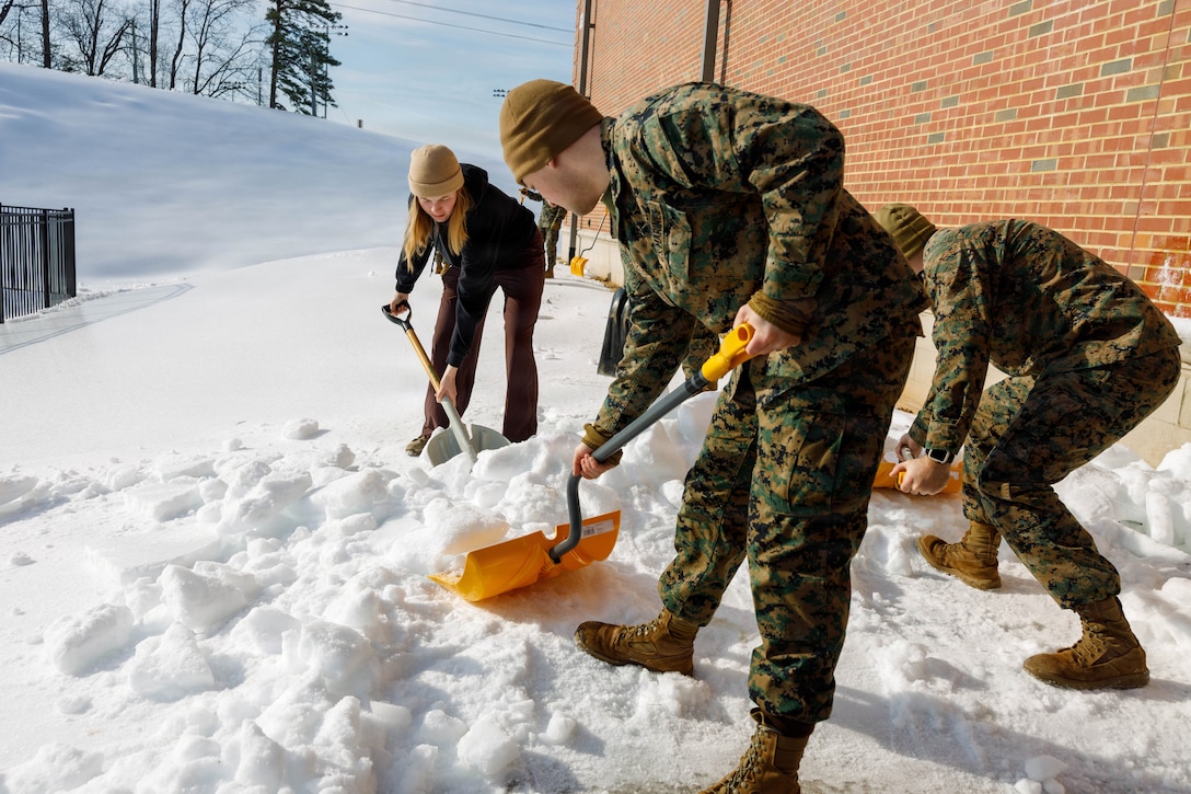 U.S. Marines with Marine Corps Base Quantico shovel snow at the Crossroads Elementary School, on MCB Quantico, Virginia, Feb. 3, 2026. Marines provided support to The Quantico Schools in response to the recent snow storm in order to ensure safety for the students, faculty, and staff attending the schools. (U.S. Marine Corps photo by Lance Cpl. Lynsee Avila-Ramirez)