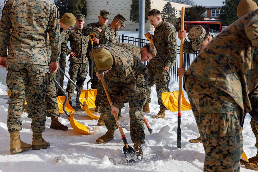 U.S. Marines with Marine Corps Base Quantico shovel snow at the Crossroads Elementary School, on MCB Quantico, Virginia, Feb. 3, 2026. Marines provided support to The Quantico Schools in response to the recent snow storm in order to ensure safety for the students, faculty, and staff attending the schools. (U.S. Marine Corps photo by Lance Cpl. Lynsee Avila-Ramirez)