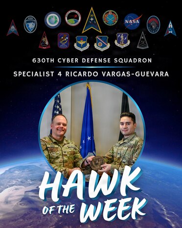 U.S. Space Force Col. James T. Horne III, left, Space Launch Delta 30 commander, presents Vandenberg’s Hawk of the Week Award to Specialist 4 Ricardo Vargas-Guevara, right, 630th Cyber Defense Squadron cyber defense operator, during a weekly installation leadership meeting.