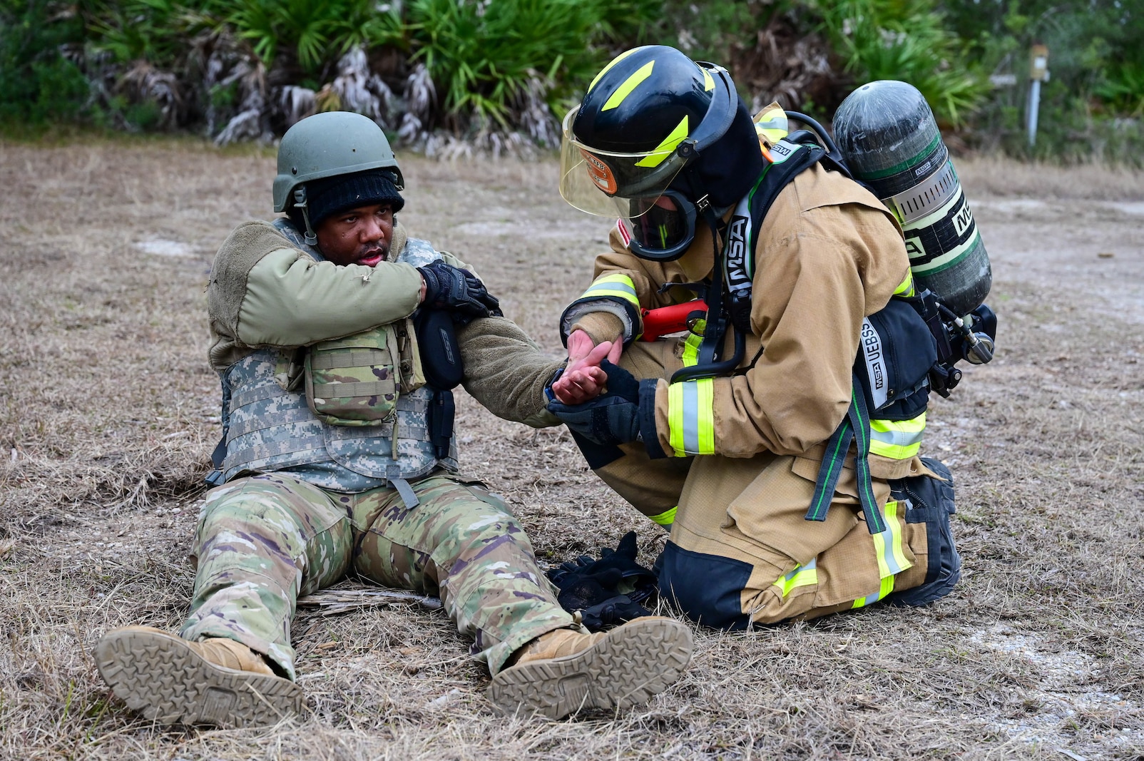 A firefighter tends to an injured Airman.