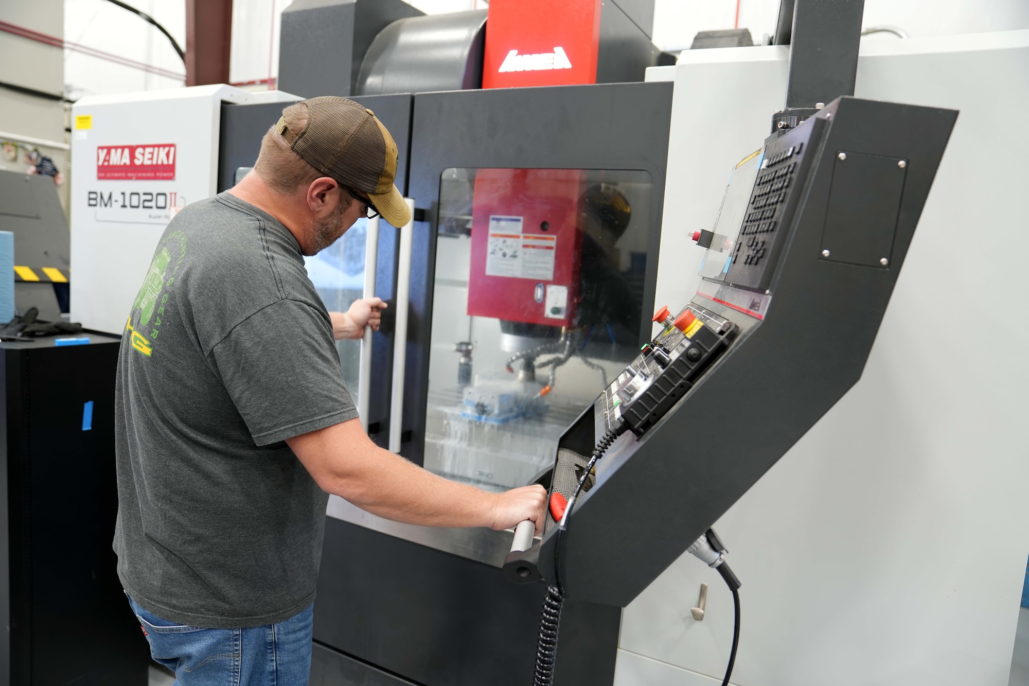 Man working on a computer controlled lathe
