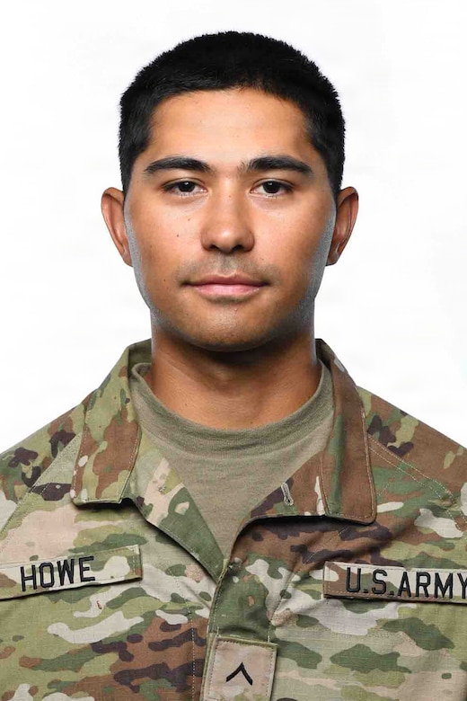 A man wearing a camouflage military uniform poses for a photo.