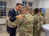 NATO Secretary General Mark Rutte shakes hands with U.S. Army Lt. Col. John Nimmons during a holiday dinner at Bemowo Piskie Training Area, Poland, Dec. 18, 2025. The engagement allowed Allied leaders to thank forward-deployed service members and recognize their role in supporting NATO’s mission. Senior NATO and Allied leader engagements demonstrate continued support for Soldiers serving their countries and the Alliance during the holiday period. (U.S. Army photo by Sgt. Eric Allen)