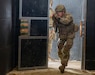 U.S. Army Sgt. 1st Class Dakota Fowler, assigned to Bravo Company, 1st Battalion, 16th Infantry Regiment, 1st Armored Brigade Combat Team, 1st Infantry Division, enters a building while executing close-quarters combat training in an urban environment for a squad live fire exercise on Novo Selo Training Area, Bulgaria, Oct. 28, 2025. Execution of squad live fire exercises increased overall lethality and warfighting readiness along NATOs Eastern Flank by training squads shoot, move, and communicate effectively in complex operational environments. (U.S. Army photo by Spc. Breanna Bradford)