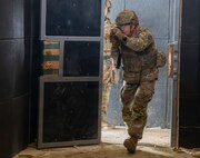 U.S. Army Sgt. 1st Class Dakota Fowler, assigned to Bravo Company, 1st Battalion, 16th Infantry Regiment, 1st Armored Brigade Combat Team, 1st Infantry Division, enters a building while executing close-quarters combat training in an urban environment for a squad live fire exercise on Novo Selo Training Area, Bulgaria, Oct. 28, 2025. Execution of squad live fire exercises increased overall lethality and warfighting readiness along NATOs Eastern Flank by training squads shoot, move, and communicate effectively in complex operational environments. (U.S. Army photo by Spc. Breanna Bradford)