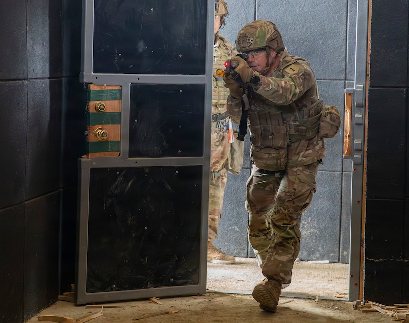 U.S. Army Sgt. 1st Class Dakota Fowler, assigned to Bravo Company, 1st Battalion, 16th Infantry Regiment, 1st Armored Brigade Combat Team, 1st Infantry Division, enters a building while executing close-quarters combat training in an urban environment for a squad live fire exercise on Novo Selo Training Area, Bulgaria, Oct. 28, 2025. Execution of squad live fire exercises increased overall lethality and warfighting readiness along NATOs Eastern Flank by training squads shoot, move, and communicate effectively in complex operational environments. (U.S. Army photo by Spc. Breanna Bradford)