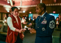 U.S. Air Force Chief Master Sgt. Anthony Thompson Jr., right, senior enlisted leader for Joint Base Anacostia-Bolling and 11th Wing command chief, and Angelina Morlock, left, a protocol specialist with the 11th WG, light a candle to honor the victims of the 2025 Potomac River aircraft collision during a remembrance ceremony at JBAB, Washington,

D.C., Jan. 29, 2026. Sixty-seven people were killed when American Airlines Flight 5342 and a U.S. Army UH-60L helicopter collided near Ronald Reagan Washington National Airport in Arlington, Va., Jan. 29, 2025. The ceremony marked the one-year anniversary of the incident and concluded with a candlelight memorial for the victims. (U.S. Air Force photo by Airman 1st Class Shanel Toussaint)