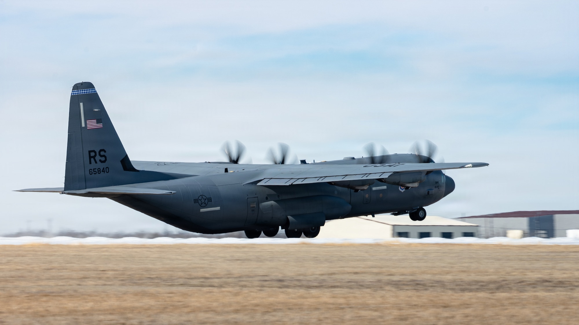 A U.S. Air Force C-130J Super Hercules departs after the airfield reopened following Winter Storm Fern at Dyess Air Force Base, Texas, Jan. 28, 2026. The 7th Civil Engineer Squadron prioritized opening the airfield during the storm, using refitted and borrowed equipment to clear inches of snow over ice. Their removal efforts accelerated operational readiness timelines despite temperatures remaining below freezing during the days and nights of the removal process. (U.S. Air Force photo by Senior Airman Jade M. Caldwell)