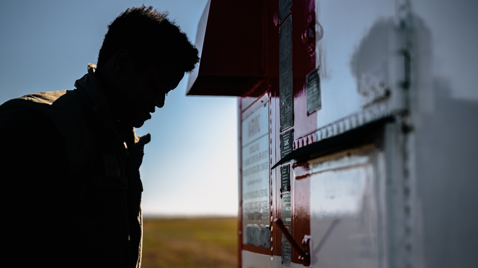 Airman inspects a localizer shelter of an instrument landing system