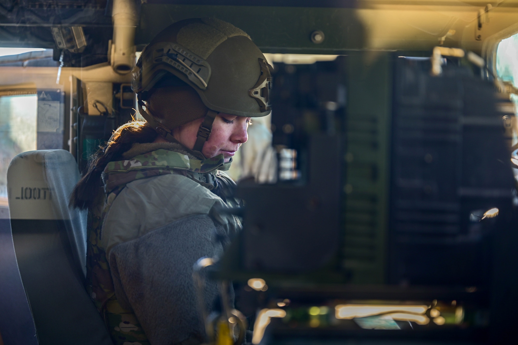 An Airman sits in a humvee.