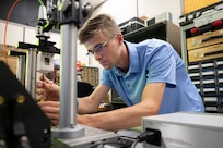 Justin Hagen, U.S. Naval Research Laboratory (NRL) intern, calibrates a piezoelectric driven flexible surface membrane in Washington, D.C., Aug. 7, 2025. Hagen participated in NRL’s Pathways Internship Program where students from a wide variety of educational institutions can explore federal careers and work in agencies while attending school. (U.S. Navy photo by Sarah Peterson) RELEASED