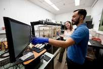 Harrison Cole (right), U.S. Naval Research Laboratory (NRL) intern, looks at images of neurons taken with an inverted microscope with Margaret Stevens, Ph.D., NRL electrical engineer, in Washington, D.C., Aug. 8, 2025. Cole participated in NRL’s Science and Engineering Apprentice Program where students work alongside researchers, attend program seminars, and deliver research presentations while exploring careers in science and technology. (U.S. Navy photo by Jonathan Steffen-Arnold)
