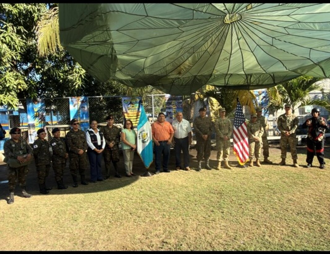 People in military uniforms, and civilians stand side by side.