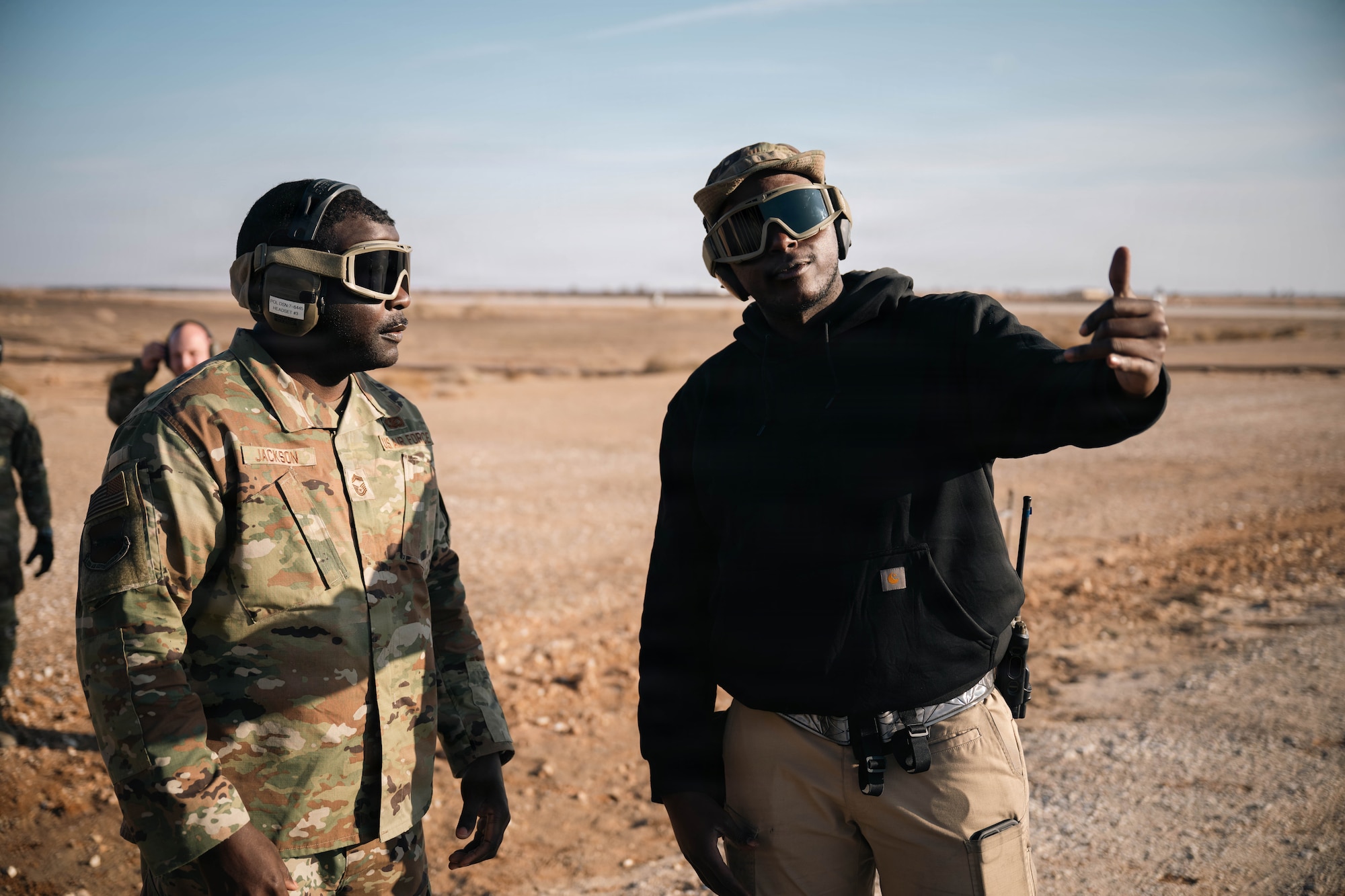 U.S. Air Force Chief Master Sgt. Nicholas Jackson, 332nd Expeditionary Air Base Group senior enlisted leader, left, listens to a safety brief by Airman 1st Class Samuel Ilet, 332nd Expeditionary Logistics Readiness Squadron fuels distribution operator, in the U.S. Central Command area of responsibility, Dec. 14, 2025.
