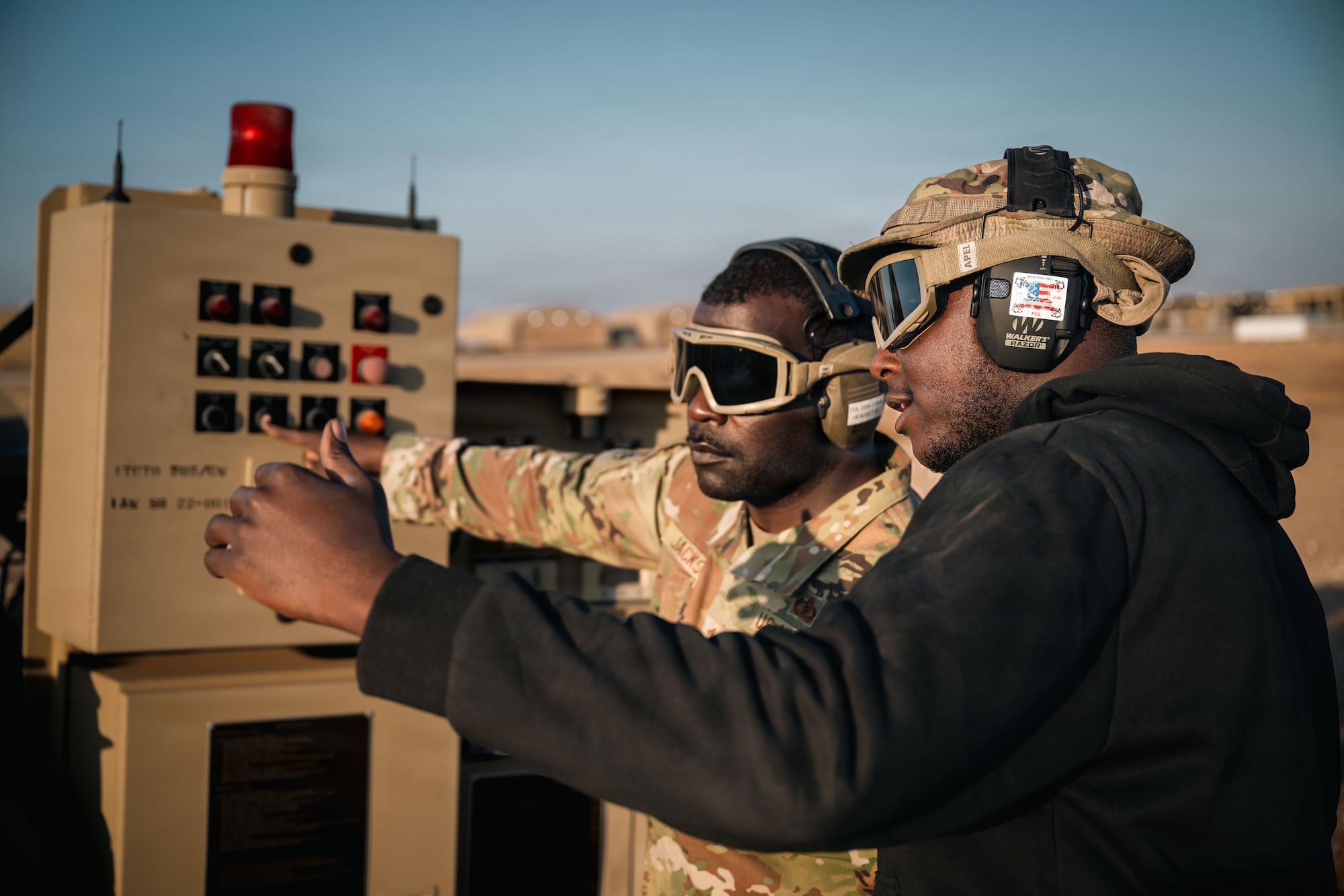 U.S. Air Force Chief Master Sgt. Nicholas Jackson, 332nd Expeditionary Air Base Group senior enlisted leader, left, and Airman 1st Class Samuel Ilet, 332nd Expeditionary Logistics Readiness Squadron fuels distribution operator, operate an R-20 expeditionary refueling system in the U.S. Central Command area of responsibility, Dec. 14, 2025.