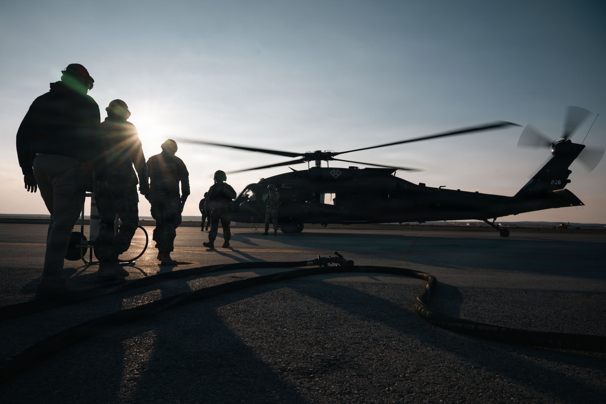 U.S. Air Force Airmen with the 332nd Air Expeditionary Wing prepare to refuel a U.S. Army UH-60 Black Hawk Helicopter in the U.S. Central Command area of responsibility Dec. 14, 2025.