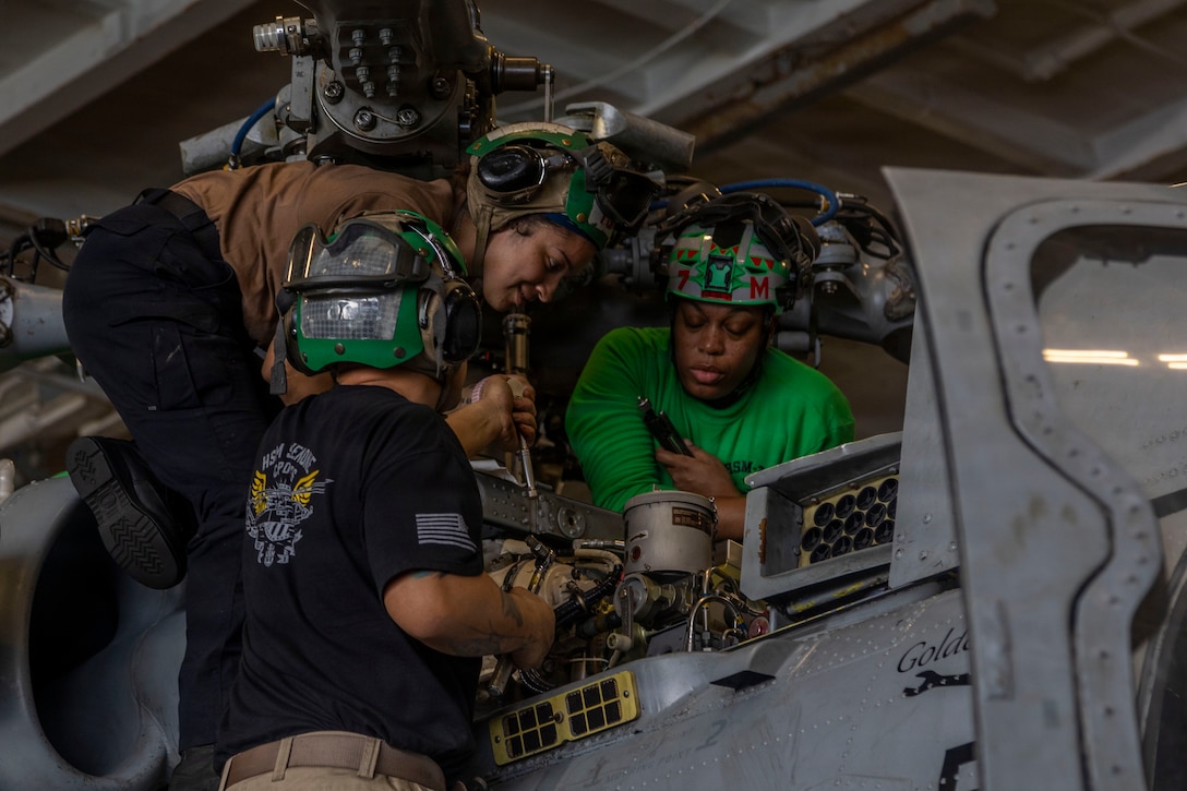 U.S. Sailors conduct maintenance on an MH-60R Sea Hawk helicopter, attached to Helicopter Maritime Strike Squadron (HSM) 71, in the hangar bay of Nimitz-class aircraft carrier USS Abraham Lincoln (CVN 72) in the Arabian Sea, Feb. 2, 2026. Abraham Lincoln is deployed to the U.S. 5th Fleet area of operations to support maritime security and stability in the U.S. Central Command area of responsibility. (U.S. Navy photo by Mass Communication Specialist Seaman Daniel Kimmelman)