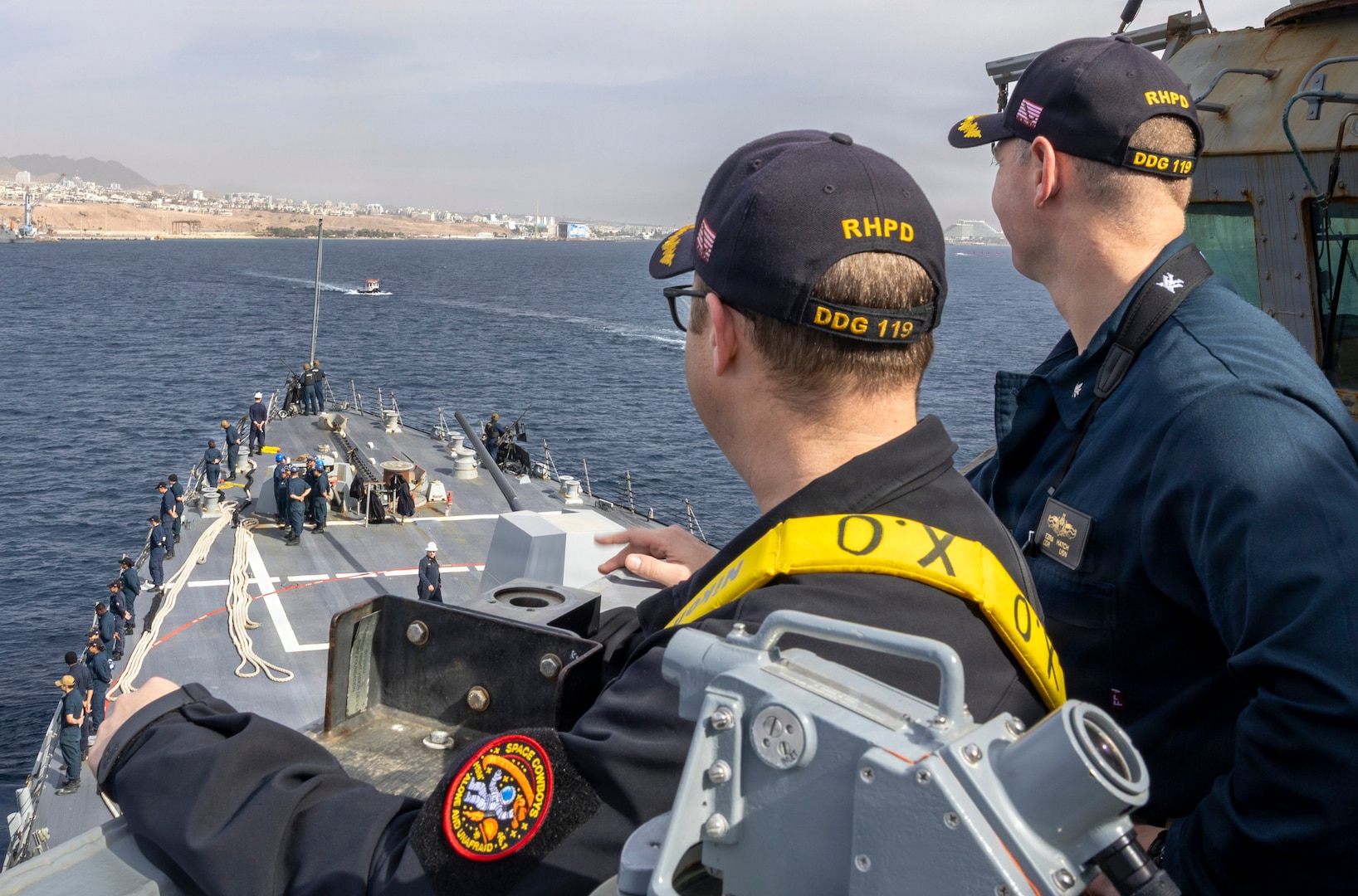 EILAT, Israel (Jan. 30, 2026) – U.S. Navy Cmdr. Ezra Hatch, commanding officer of Arleigh Burke-class guided-missile destroyer USS Delbert D. Black (DDG 119), and Cmdr. Justin Crabb, executive officer of Delbert D. Black, observe Sailors manning the rails during a scheduled routine port visit to Eilat, Israel, Jan. 30. Delbert D. Black is deployed to the U.S. 5th Fleet area of operations to support maritime security and stability in the U.S. Central Command area of responsibility. (U.S. Navy photo by Mass Communication Specialist 1st Class Wendy Arauz)