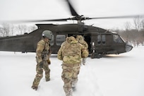 U.S. Soldiers with the 177th Military Police Brigade, Michigan National Guard, board a U.S. Army UH-60 Black Hawk aircraft assigned to the 3rd Battalion, 238th Aviation Regiment General Support Battalion, Michigan National Guard, during Northern Strike 26-1, Jan. 28, 2026, at Camp Grayling, Michigan.