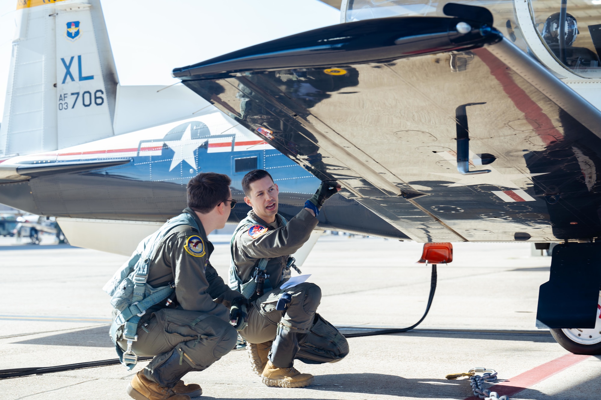U.S. Air Force Capt. Garrett Sheehan, 41st Flying Training Squadron, instructor pilot, left, and U.S. Air Force Eric Maltz, 434th Flying Training Squadron, instructor pilot, right, perform a pre-flight checklist during Rapid Crew Swap (RCS) operations at Laughlin Air Force Base, Texas, Jan. 29, 2026. Laughlin Air Force Base functions as the proving ground for RCS procedures, allowing pilots from other undergraduate pilot training bases to gain firsthand experience with the updated training construct. (U.S. Air Force photo by Airman 1st Class Harrison Sullivan)