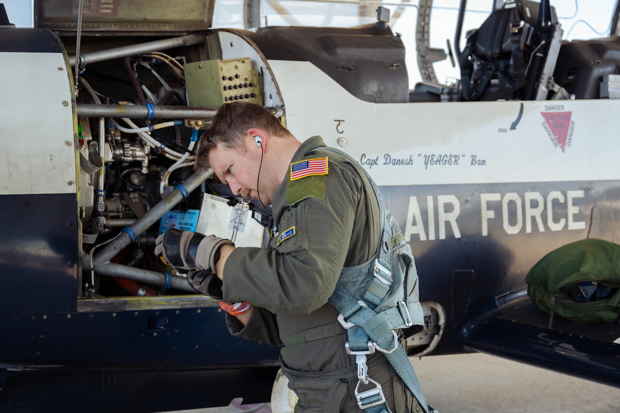 U.S. Air Force Capt. Dane Butler, 85th Flying Training Squadron, instructor pilot, checks the engine oil on a T-6A Texan II during Rapid Crew Swap operations at Laughlin Air Force Base, Texas, Jan. 29, 2026. The procedure enables aircraft to return to flight more quickly by removing the requirement for maintenance inspections between local sorties, increasing operational efficiency and pilot throughput. (U.S. Air Force photo by Airman 1st Class Harrison Sullivan)