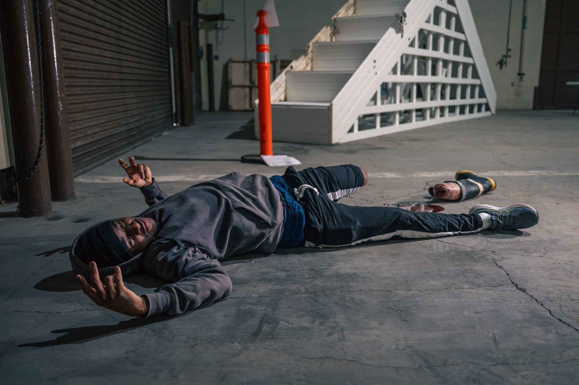 Simulated injured victim poses for a photo while laying on the floor.