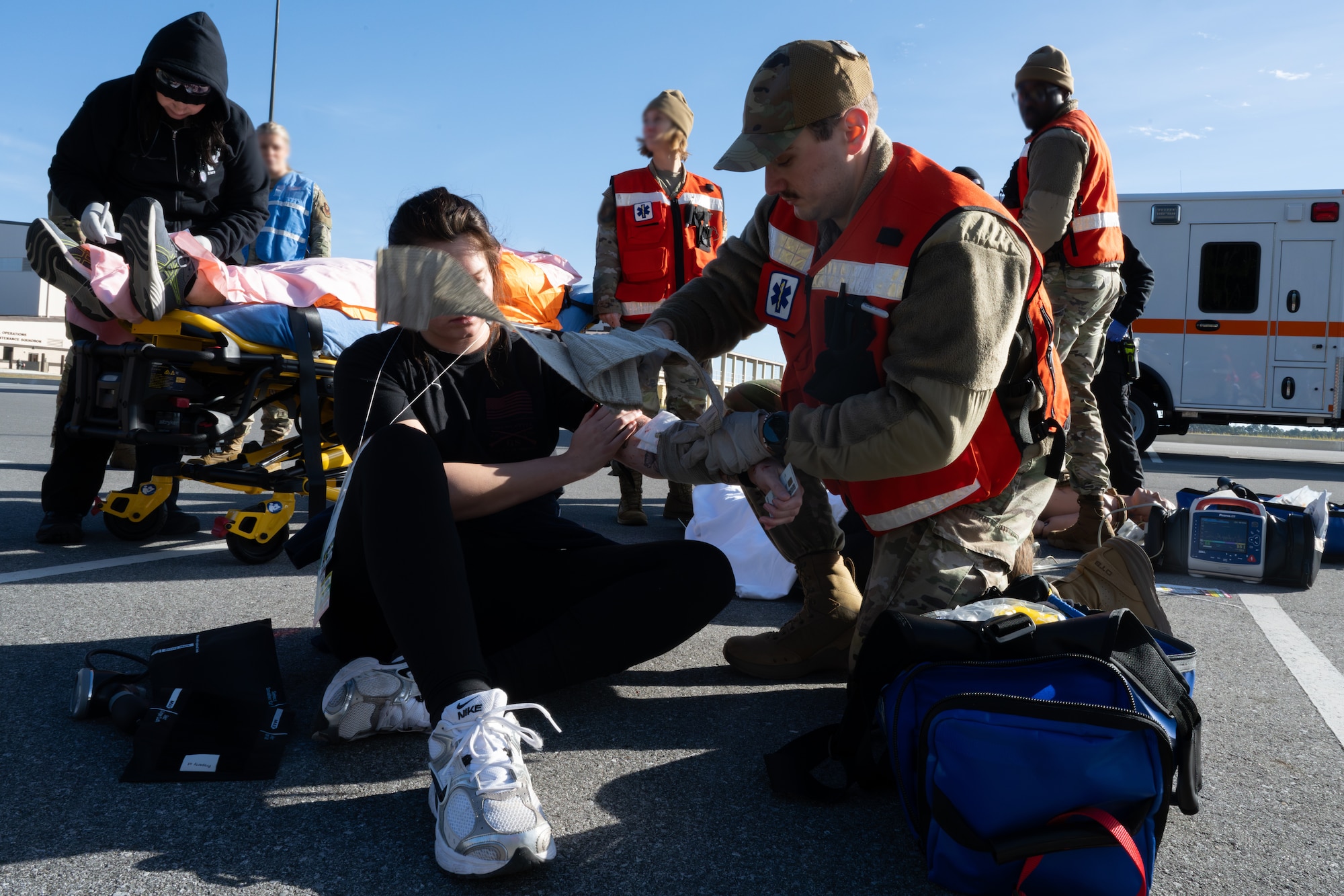 A medical technician assigned to the 1st Special Operations Wing treats a volunteer with simulated injuries during an active-shooter exercise at Hurlburt Field, Florida, Jan. 28, 2026.