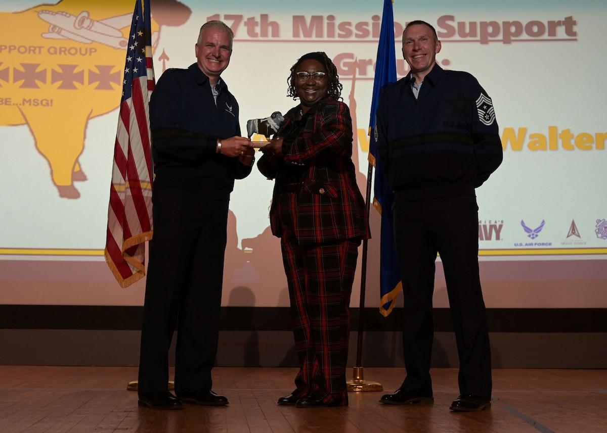 U.S. Air Force Col. Matthew Norton, 17th Training Wing commander, and Chief Master Sgt. Derek Neil, 17th TRW command chief,  present the Civilian Non-Supervisory Category II of the Quarter award to Mrs. Alicia Wilder-Walters, 17th Force Support Squadron educational specialist. 17th FSS is responsible for programs covering military and civilian personnel, education services and family support for technical training students.   (U.S. Air Force photo by Senior Airman Evelyn J. D'Errico)