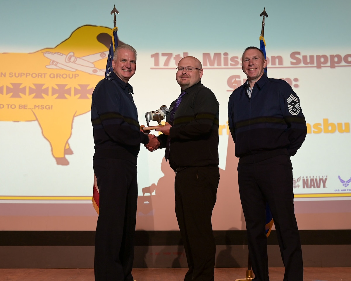 U.S. Air Force Col. Matthew Norton, 17th Training Wing commander, and Chief Master Sgt. Derek Neil, 17th TRW command chief,  present the Civilian Supervisory Category II of the Quarter award to Mr. Brian Stansbury, 17th Force Support Squadron food service specialist. 17th FSS is responsible for programs covering military and civilian personnel, education services and family support for technical training students.  (U.S. Air Force photo by Senior Airman Evelyn J. D'Errico)