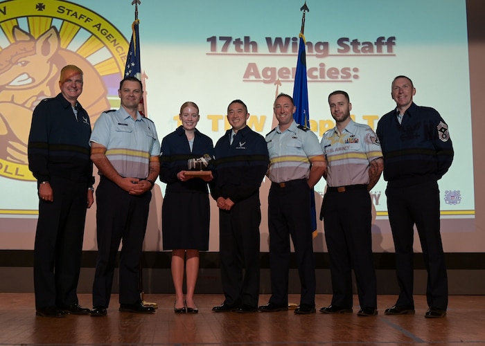 The 17th Training Wing Chapel Corps team pose for a group photo with 17th TRW leadership during the 17th TRW 4th Quarterly Awards Ceremony at the base theater, Goodfellow Air Force Base, Texas, Jan. 30, 2026. They received the Team of the Quarter award to honor all members for their exceptional accomplishments and performance. (U.S. Air Force photo by Senior Airman Evelyn J. D'Errico)
