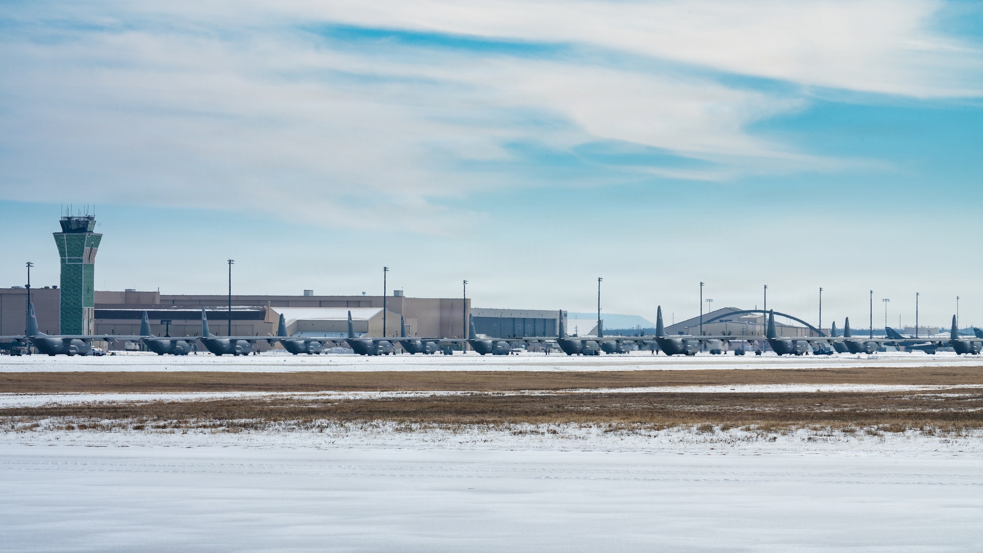 U.S. Air Force C-130J Super Hercules aircraft assigned to the 317th Airlift Wing sit on the parking apron following Winter Storm Fern at Dyess Air Force Base, Texas, Jan. 28, 2026. Instead of waiting for solar melt, the 7th Civil Engineer Squadron reorganized efforts to reopen the airfield on an accelerated timeline. (U.S. Air Force photo by Senior Airman Jade M. Caldwell)