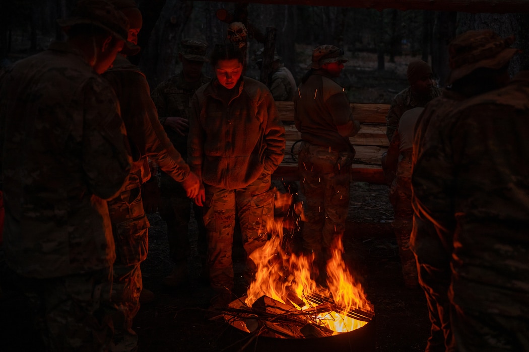 Airmen warming by the fire.