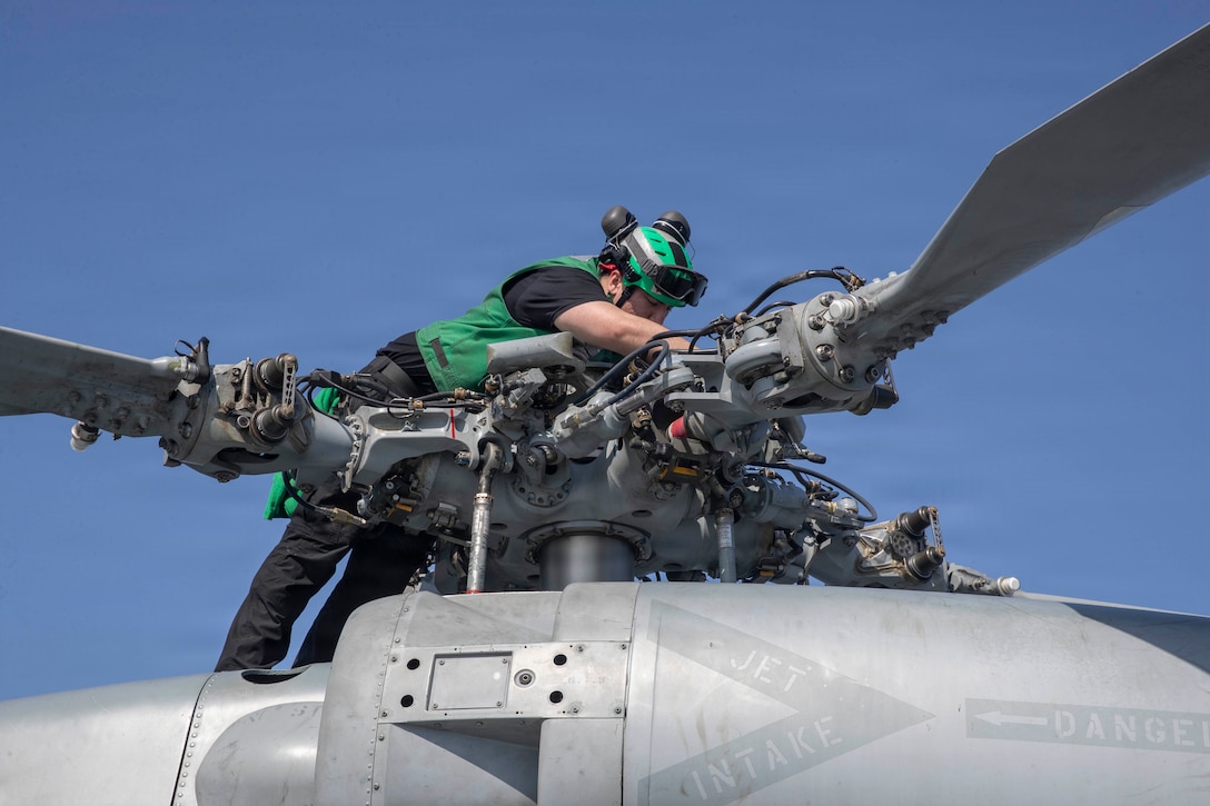 U.S. Navy Aviation Electrician’s Mate 2nd Class Samuel Peters conducts maintenance on an MH-60R Sea Hawk helicopter, attached to Helicopter Maritime Strike Squadron (HSM) 71, on the flight deck of Nimitz-class aircraft carrier USS Abraham Lincoln (CVN 72) in the Arabian Sea, Feb. 2, 2026. Abraham Lincoln is deployed to the U.S. 5th Fleet area of operations to support maritime security and stability in the U.S. Central Command area of responsibility. (U.S. Navy photo by Mass Communication Specialist Seaman Apprentice Cesar Zavala)