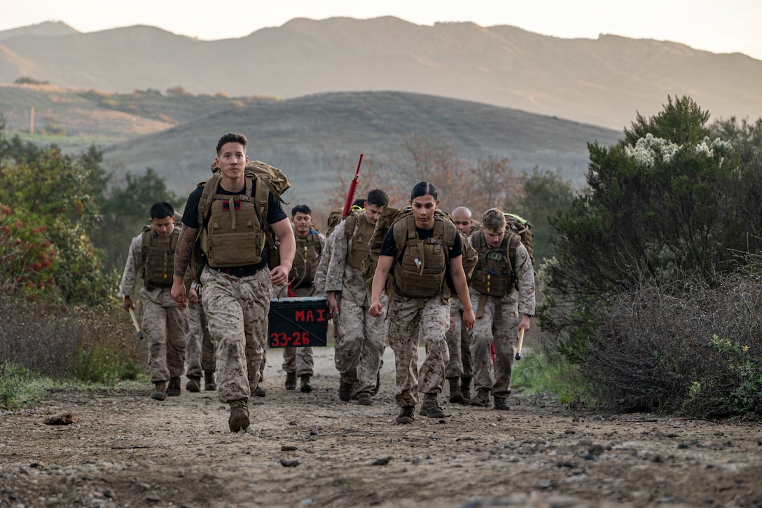 U.S. Marines participate in a supply run during a martial arts instructor course hosted by 1st Intelligence Battalion at Marine Corps Base Camp Pendleton, California, Dec. 18, 2025. The culminating event combines multiple physical training events to ensure Marines are ready to meet the demands of becoming a martial arts instructor. (U.S. Marine Corps photo by Sgt. Sean Potter)