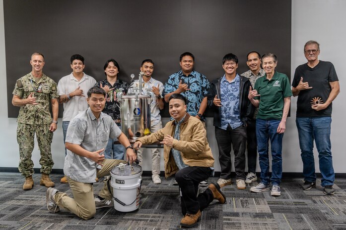 Capt. Ryan McCrillis, commander of the Pearl Harbor Naval Shipyard and Intermediate Maintenance Facility, poses with University of Hawaii Manoa students following their final presentations on Dec. 5, 2025.