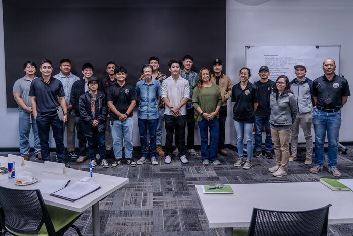 University of Hawaii Manoa students and shipyard employees who are alumni of the cooperative education program gather for a photo after a Q&A session at PHNSY & IMF on Oct. 22, 2025.