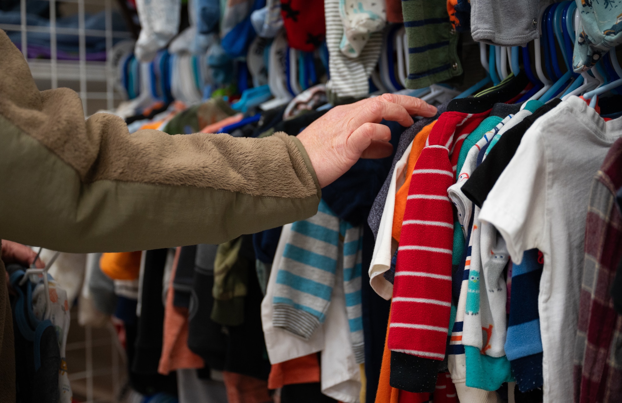 A U.S. airman observes clothes while shopping at the Airman’s Attic on Maxwell Air Force Base, Alabama, Jan. 30, 2026.