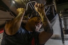 U.S. Navy Aviation Structural Mechanic 1st Class George Vasquez conducts maintenance on an F/A-18E Super Hornet, attached to Strike Fighter Squadron (VFA) 14, in the hangar bay of Nimitz-class aircraft carrier USS Abraham Lincoln (CVN 72) in the Arabian Sea, Feb. 2, 2026. Abraham Lincoln is deployed to the U.S. 5th Fleet area of operations to support maritime security and stability in the U.S. Central Command area of responsibility. (U.S. Navy photo by Mass Communication Specialist Seaman Daniel Kimmelman)