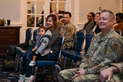 Angela and Carson Kido, wife and son of U.S. Air Force Maj. Brandon K. Kido, 11th Contracting Squadron incoming commander, observe the 11th CONS assumption of command ceremony at Joint Base Anacostia-Bolling, Washington, D.C., Jan. 23, 2026. Established in 2020 with the lead service transfer of JBAB from the U.S. Navy to the Air Force and the activation of the 11th Wing, the 11th CONS oversees the government purchase card program and manages purchasing and acquisition processes on JBAB. (U.S. Air Force photo by Airman 1st Class Shanel Toussaint)