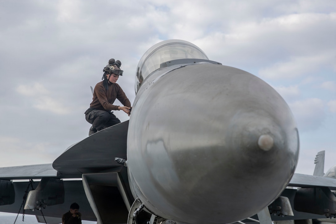 U.S. Navy Aviation Ordnanceman Airman Violet Nicolosi conducts maintenance on an F/A-18F Super Hornet, attached to Strike Fighter Squadron (VFA) 41, on the flight deck of Nimitz-class aircraft carrier USS Abraham Lincoln (CVN 72) in the Arabian Sea, Feb. 1, 2026. Abraham Lincoln is deployed to the U.S. 5th Fleet area of operations to support maritime security and stability in the U.S. Central Command area of responsibility. (U.S. Navy photo by Mass Communication Specialist Seaman Apprentice Cesar Zavala)