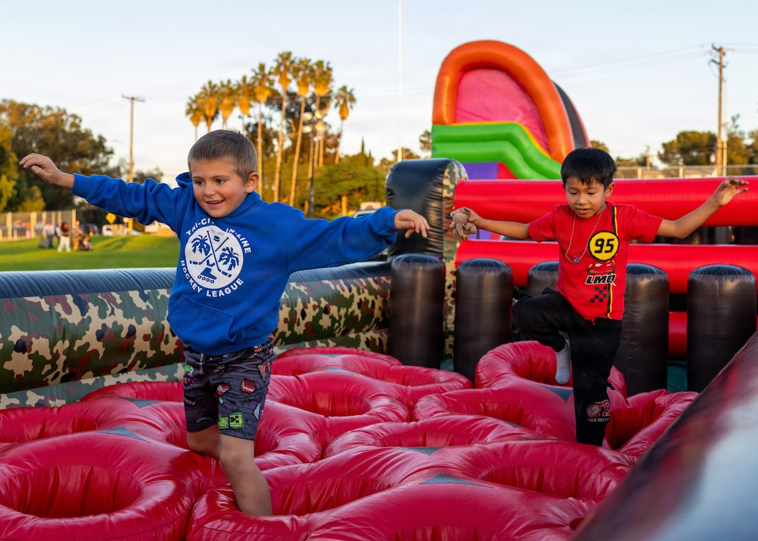Children play on the inflatables during the Marine Corps Community Services Camp Pendleton Winter Carnival at Marine Corps Base Camp Pendleton, Calif., Jan. 30, 2026. The event featured live music by Gary Sinise and the Lt. Dan Band, carnival games and food trucks to bring the community together and celebrate the winter season. (U.S. Marine Corps photo by Lance Cpl. Sherchand)