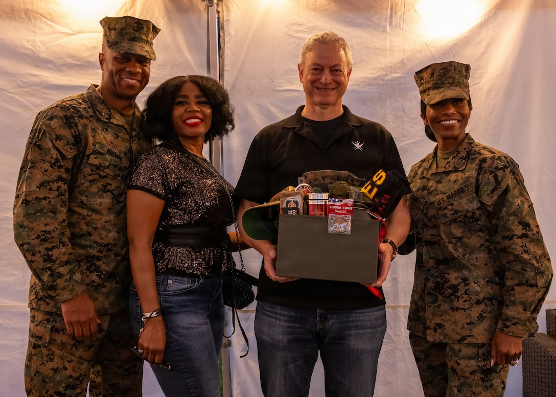 Nick I. Brown, commanding general of Marine Corps Installations West, Marine Corps Base Camp Pendleton, far left, and Sgt. Maj. Sherri N. Cook, senior enlisted leader of Marine Corps Installations West, pose for a group photo with Brown’s wife, Anneese Brown, middle left, and Gary Sinise, middle right, during the Marine Corps Community Services Camp Pendleton Winter Carnival at Marine Corps Base Camp Pendleton, Calif., Jan. 30, 2026. The event featured live music by Gary Sinise and the Lt. Dan Band, carnival games and food trucks to bring the community together and celebrate the winter season. (U.S. Marine Corps photo by Lance Cpl. Sherchand)