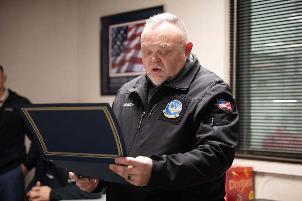 Todd Dennison, U.S. Air Force 97th Maintenance Squadron deputy director, announces the Knuckle Buster award winners at Altus Air Force Base, Oklahoma, Jan. 22, 2026. Individuals received the Knuckle Buster award in recognition of their outstanding repairs to a KC-135 Stratotanker aircraft after a severe bird strike. (U.S. Air Force photo by Airman 1st Class Nathan Langston)