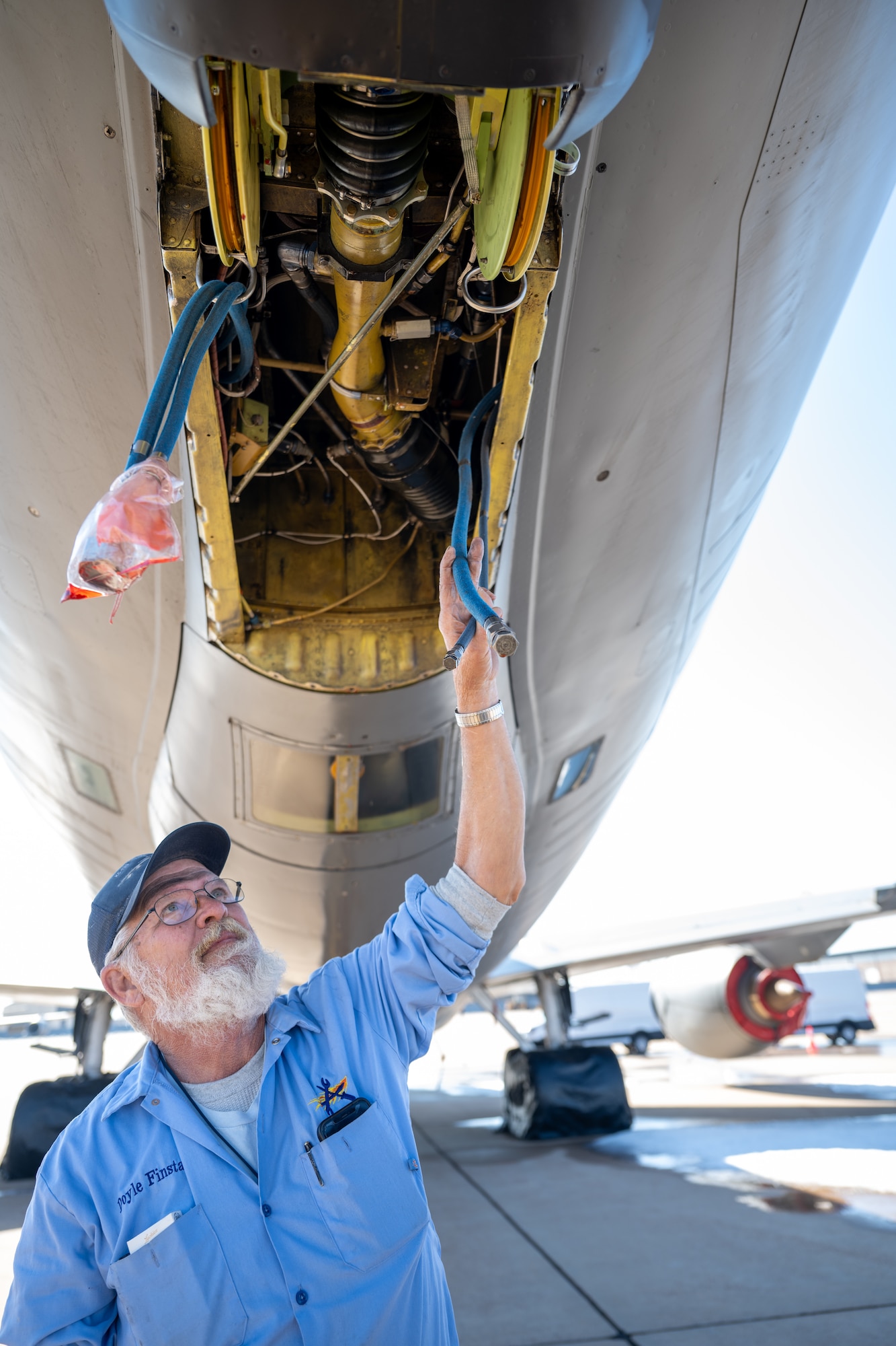 Doyle Finstad, U.S. Air Force 97th Aircraft Maintenance Squadron work leader, visually inspects the boom hydraulic lines of a KC-135 Stratotanker aircraft at Altus Air Force Base, Oklahoma, Jan. 30, 2026. Hydraulic pressure powers the KC-135’s boom arm, allowing the boom operator to raise, lower, and steer it during aerial refueling. (U.S. Air Force photo by Airman 1st Class Nathan Langston)