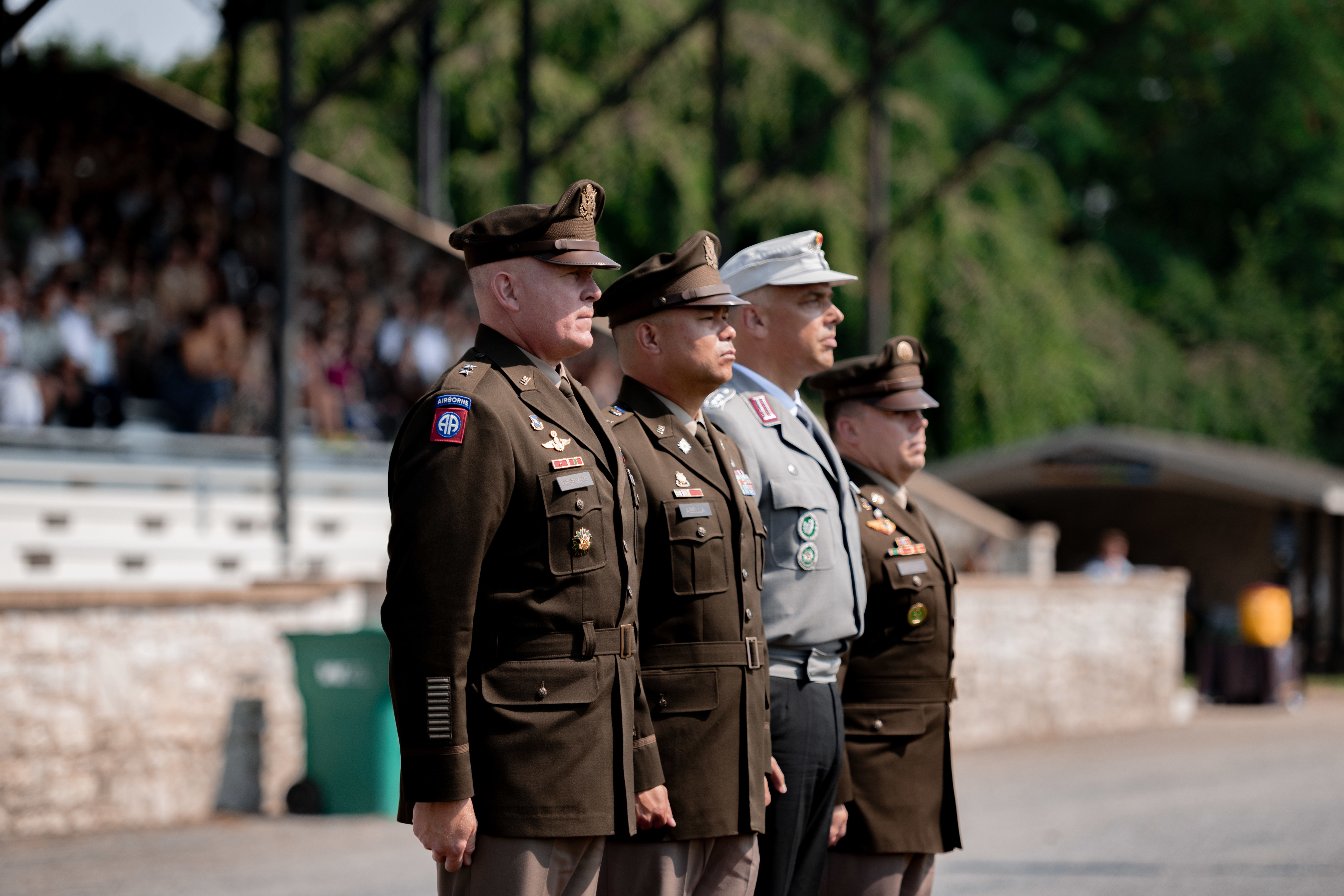 Four military officers stand at attention.