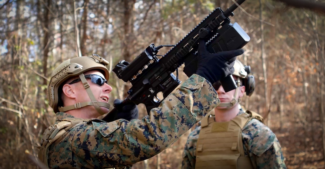 Two Marines working together on the deployment of the Organic Counter Small UAS