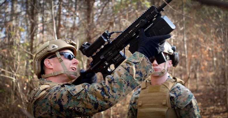 Two Marines working together on the deployment of the Organic Counter Small UAS